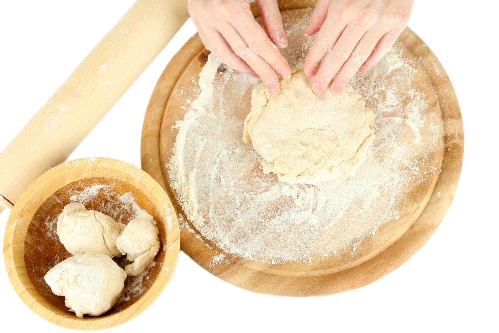 Hands forming dough in bowl